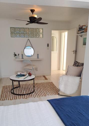 a living room with a table and a chair at The Starfish View in Grotto Bay