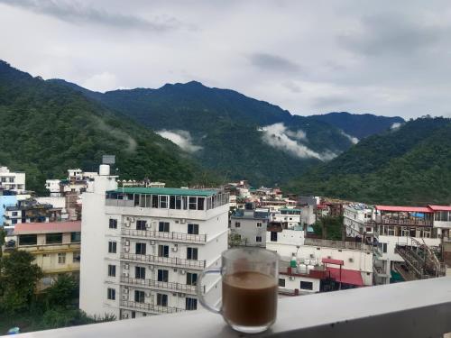 a cup of coffee sitting on top of a building at Ima Ganga Hotel - Aesthetic, Quite Mountain View Rooms with netflix, free airport pickup for 7 or more nights booking in Rishīkesh