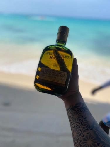 a person with a bottle of alcohol on their arm at Brisas del Mar Barú in Playa Blanca