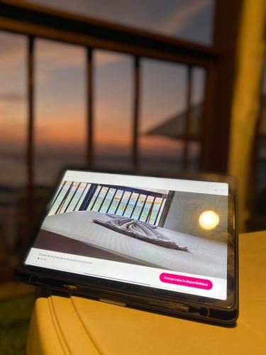 a laptop computer sitting on top of a table at Brisas del Mar Barú in Playa Blanca