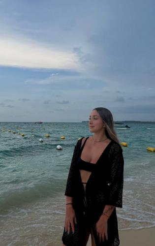 a woman standing on the beach near the ocean at Brisas del Mar Barú in Playa Blanca