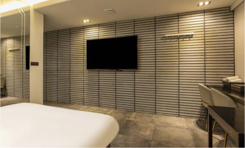 a room with a television on a wall at Hotel 99 Prestige in Seoul