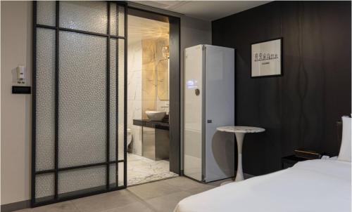 a bedroom with a bed and a sliding glass door at Hotel 99 Prestige in Seoul