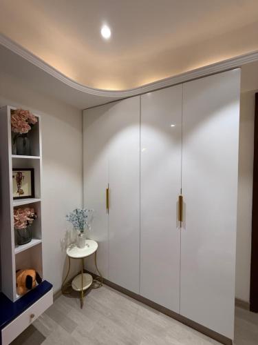 a walk in shower in a room with a table at Atrium by Bali in New Delhi