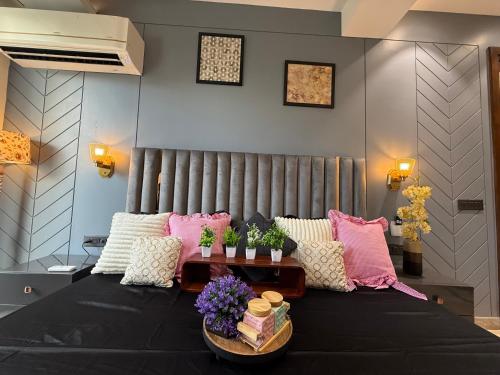 a bedroom with a bed with pink and white pillows at Atrium by Bali in New Delhi