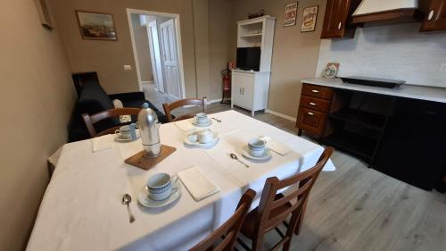 a kitchen with a white table with chairs and a counter at Casa Vacanze Stefania in Maccarese