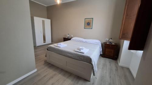 a bedroom with a bed with two towels on it at Casa Vacanze Stefania in Maccarese