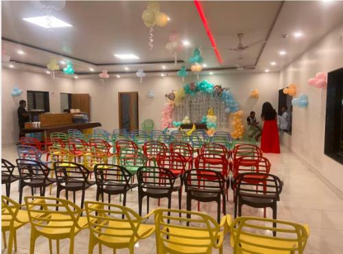 a room with a bunch of chairs and a table at The Orange Flag - Renuka Hotel in Waluj Buzurg