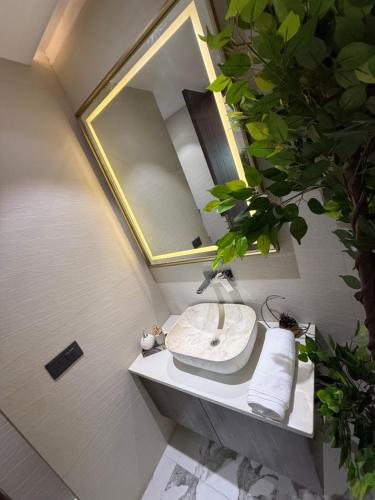 a bathroom with a sink and a mirror at Atrium by Bali in New Delhi