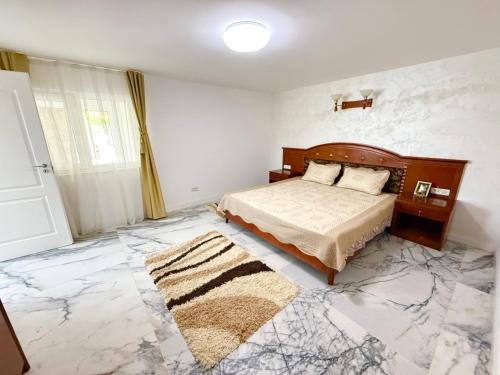 a bedroom with a bed and a marble floor at IsTh Wave House in Vadu