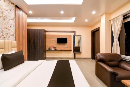 a living room with a bed and a television at Super Townhouse OAK Bulbuli Neer in Kolkata