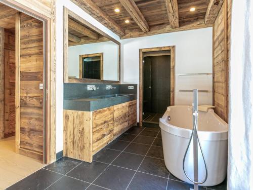 a bathroom with a large tub and a sink at Penthouse de Prestige au Cœur de Val-d'Isère, 5 Ch, Wifi - FR-1-694-430 in Val dʼIsère