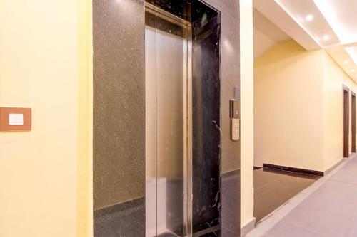 a elevator in a hallway in a building at Super Townhouse OAK Bulbuli Neer in Kolkata