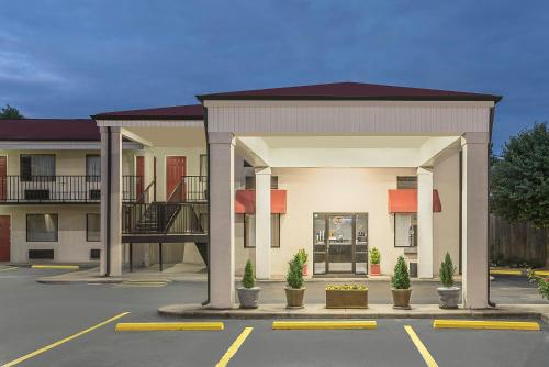 a building with a parking lot in front of it at Super 8 by Wyndham Bryant Little Rock Area in Bryant