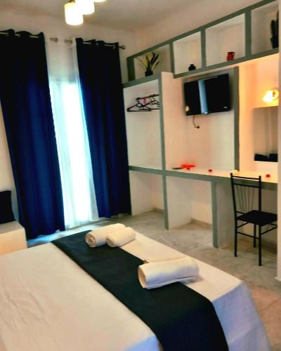 a bedroom with a bed with two towels on it at AGAPI apartments in Kithnos