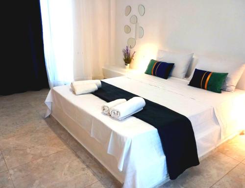 a bedroom with two beds with towels on them at AGAPI apartments in Kithnos