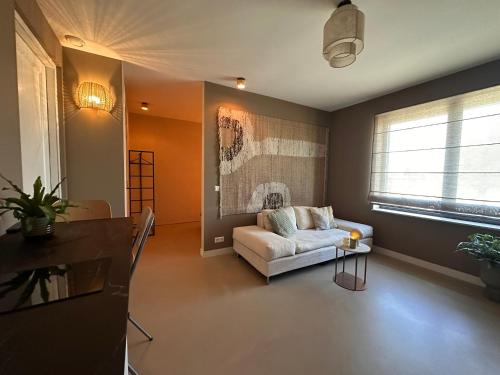 a living room with a couch and a window at City & Nature-Amsterdam NextDoor Free parking 8 person 2 kitchens in Landsmeer