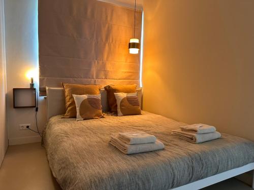 a bedroom with a bed with two towels on it at City & Nature-Amsterdam NextDoor Free parking 8 person 2 kitchens in Landsmeer