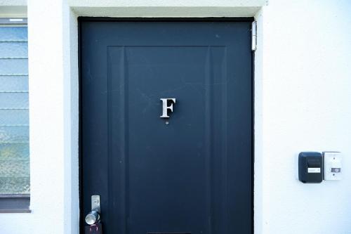 a blue door with the letter f on it at 湯乃荘 in Hakone