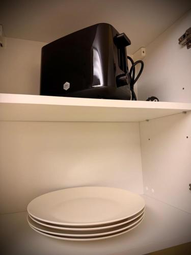 a shelf with a stack of plates on it at Villa 16 in Kivik