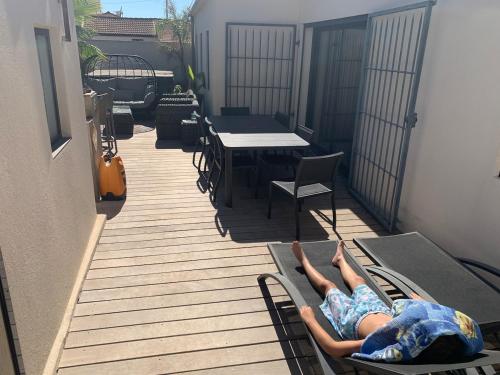 a couple of people laying on chairs on a deck at DIGITONE By GATES in Marignane