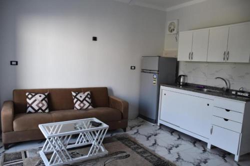 a living room with a couch and a kitchen at Bastet Retreat Hotel in Luxor