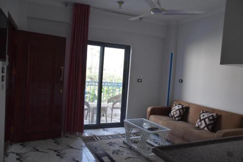 a living room with a couch and a glass table at Bastet Retreat Hotel in Luxor
