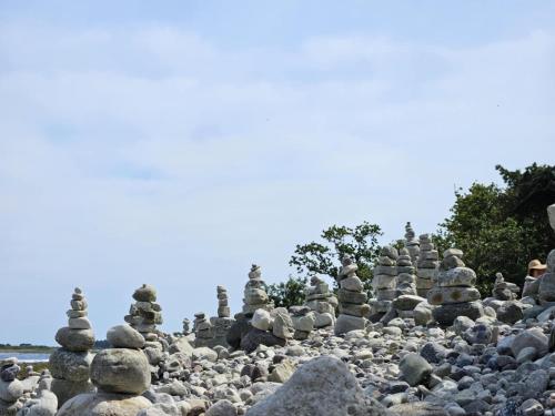 a large pile of rocks on a beach at Trevlig fritidshus på Norra Öland in Löttorp