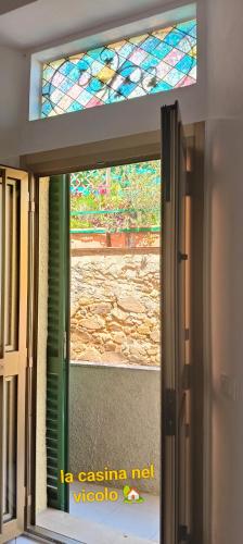 an open door with a stained glass window at La casina nel vicolo in Piombino
