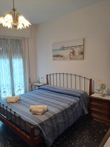 a bedroom with a bed with two towels on it at Appartamento Miramare in Vado Ligure