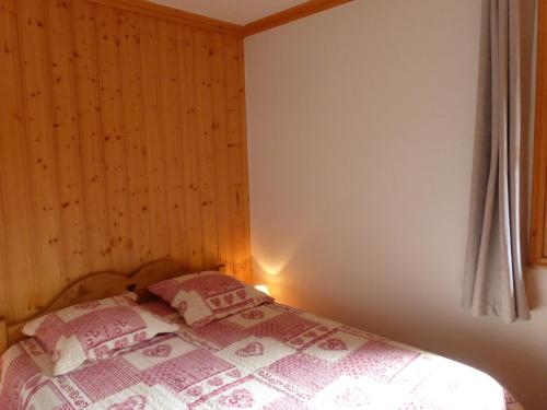 莱斯奥琉斯Charmant 2 pièces avec terrasse, 4 pers, Méribel, animaux admis, WIFI, 3* - FR-1-411-379的一间卧室配有一张粉色和白色床单。