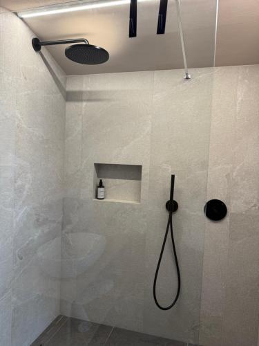 a bathroom with a shower with a shower head at Hotel Nevada in Bormio