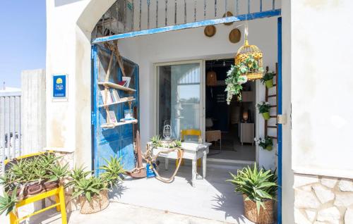 an entrance to a house with a blue door at Lovely Home In Punta Braccetto in Punta Braccetto