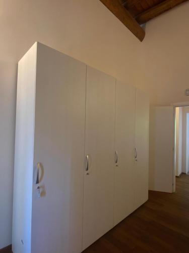 a room with white cabinets and a wooden floor at Agriturismo Cascina Mirandola in Como