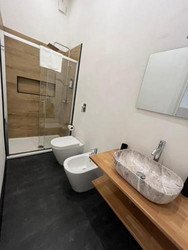 a bathroom with a toilet and a sink at La Terrazza in centro in Marsala