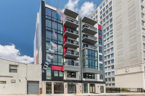 a tall building with american flags in front of it at Stay at Luna on N 11th St in Philadelphia