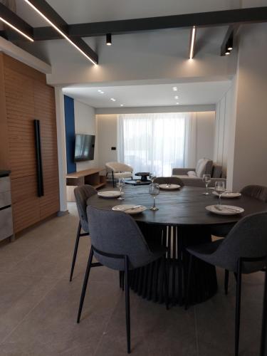 a dining room with a large table and chairs at Hesperian Luxury Villas in Chania Town