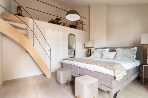 a bedroom with a bed and a stair case at Rooms With A View in Ghent