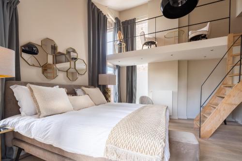 a bedroom with a large bed and a staircase at Rooms With A View in Ghent