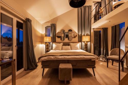 a bedroom with a large bed and windows at Rooms With A View in Ghent