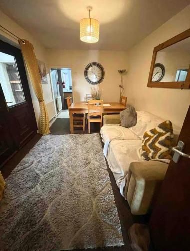 a living room with a bed and a dining room table at 284 - Room 3 - Beachfront in Swansea