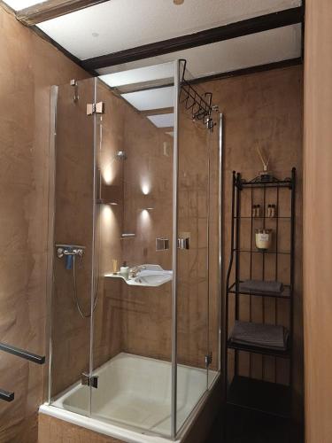 a bathroom with a shower and a sink at Konsdreffermillen B&B in Müllerthal