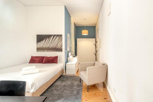 a bedroom with a bed and a chair at Downtown Riverside II by Homing in Lisbon