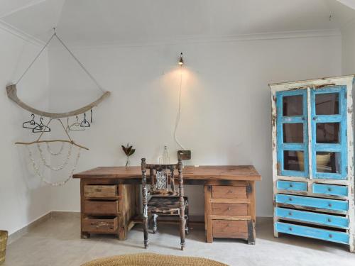 an office with a desk and a chair and a window at Paje By Night Bungalows in Paje