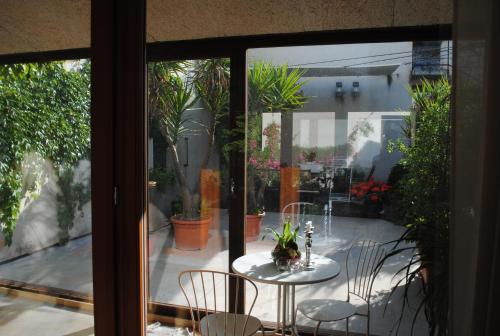 a patio with a table and chairs and potted plants at B&B Casa Zia Cianetta Residenza di Campagna in Capodacqua di Foligno