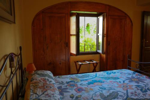 a bedroom with a bed and a window at La casa Arancione in Boves