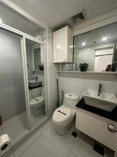 a bathroom with a toilet and a sink and a shower at A place to stay in Iloilo City