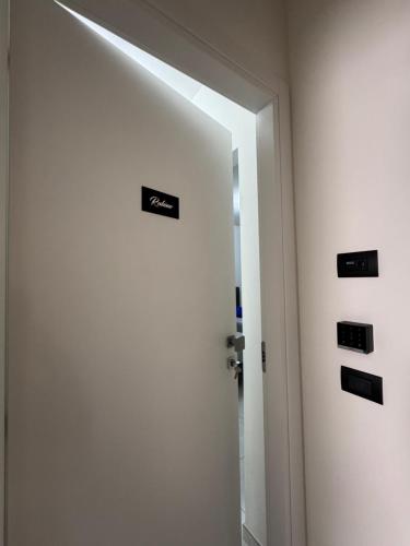 a room with a door with signs on it at B&B Orio Affittacamere Foresteria Lombarda in Grassobbio