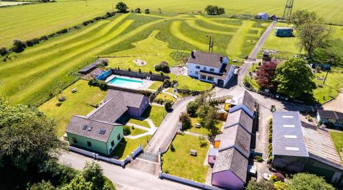 an aerial view of a house with a yard at Trenewydd Farm Holiday Cottages in Cardigan