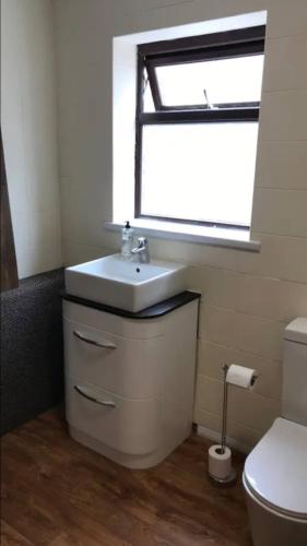 a bathroom with a sink and a toilet at 284 - Room 5 - Beachfront - Fantastic sea views in Swansea